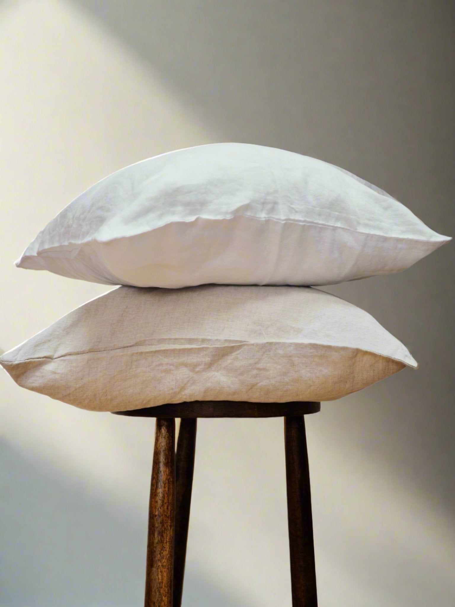Linen Cushion Covers in Oatmeal - TSL | luxury linen pillow covers placed on a stool