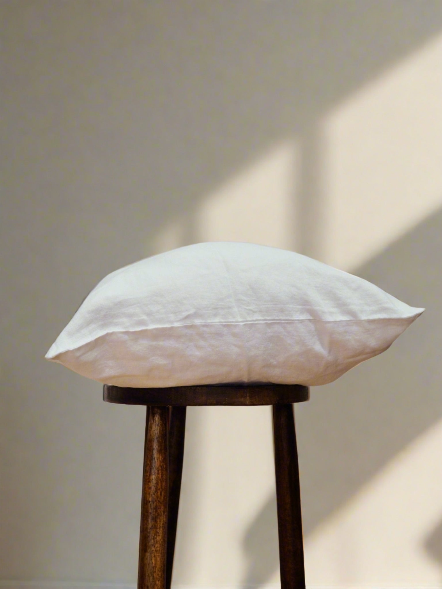 Pure French Linen Cushion Cover in White - TSL, placed on a stool
